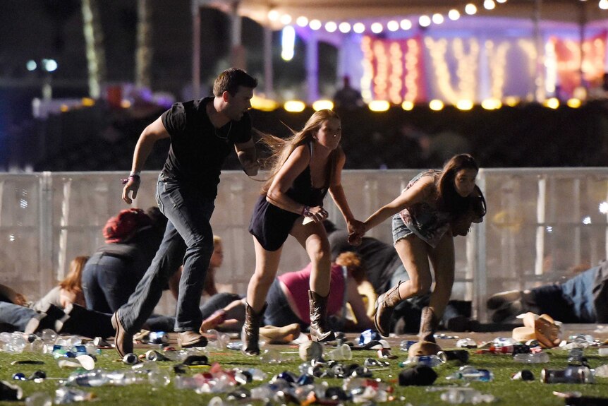 People run from the Route 91 Harvest country music festival