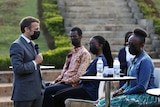French President Emmanuel Macron talks to students in Rwanda