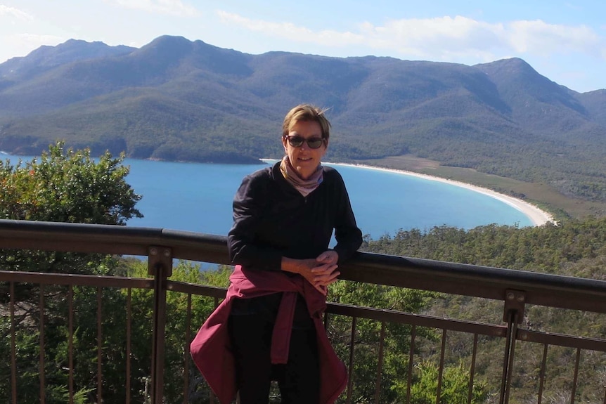 Karen McFarland standing at a lookout in Tasmania