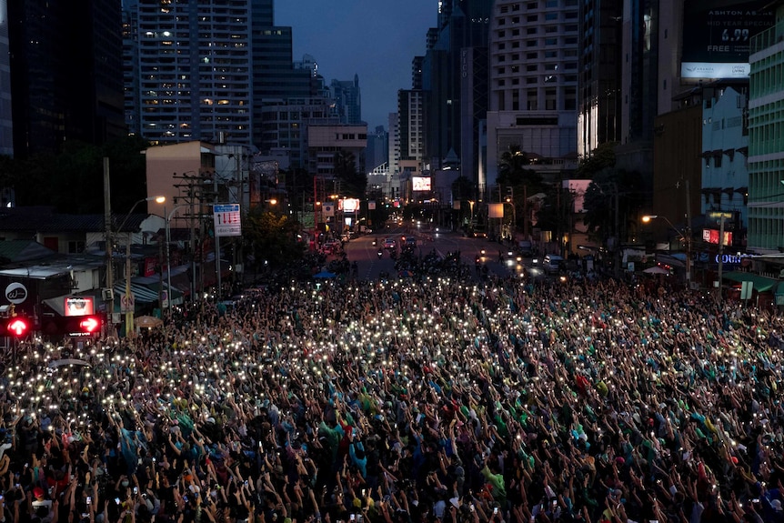 Thousands of pro-democracy supporters in Thailand wave their mobile phones with flash on during a protest.