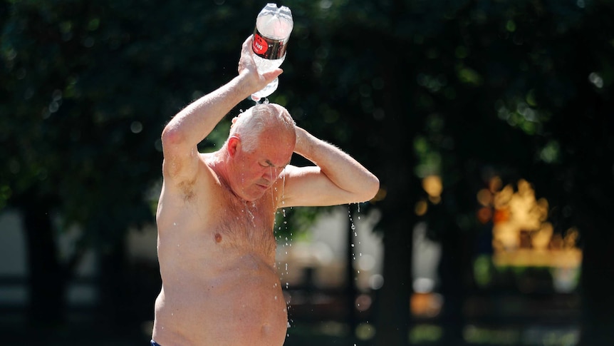 A man cools himself with water at Ada Ciganlija lake in the Serbian capital, Belgrade, Wednesday, June 26, 2019.