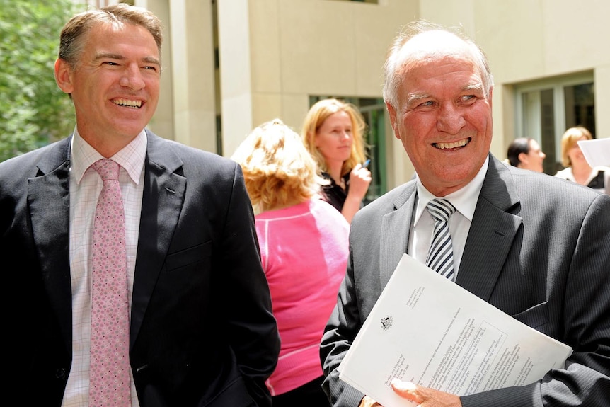 Rob Oakeshott (left) and Tony Windsor leave a press conference.