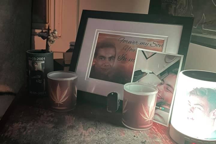 Photo frames and candles  paying tribute to a boy killed in a crash.