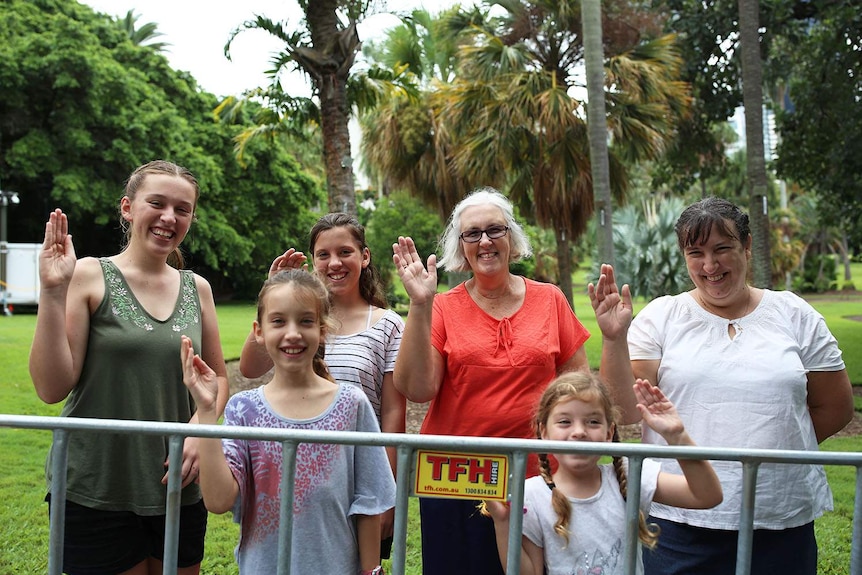 A group of six people wave at City Botanic gardens