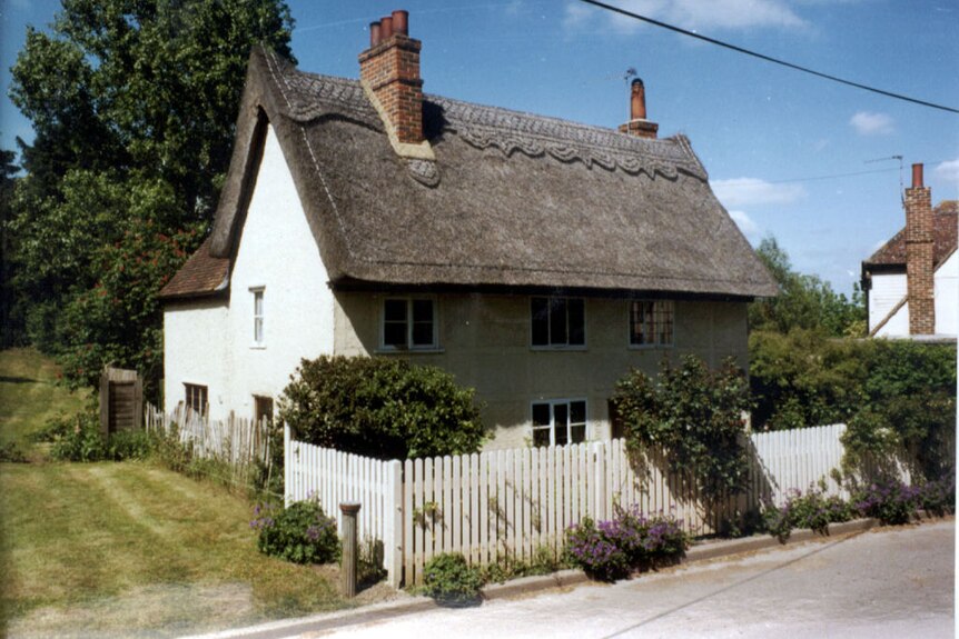 Small older cottage with thatched roof 