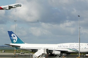 A Qantas A380 Airbus takes off in front of an Air New Zealand 747 at Auckland International Airport