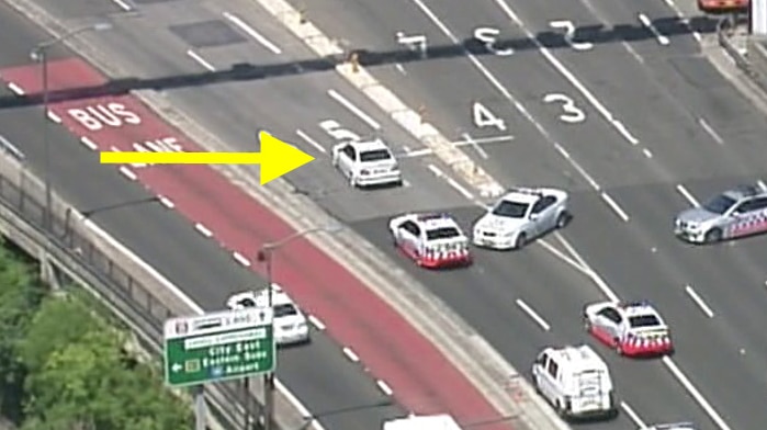 Police vehicles follow a car through Sydney