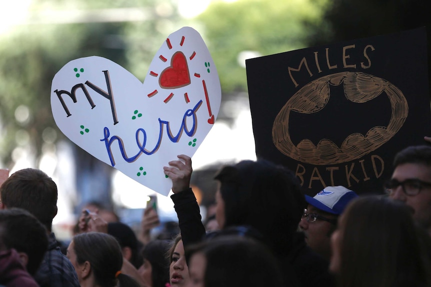 'Batkid' fans hold signs in support