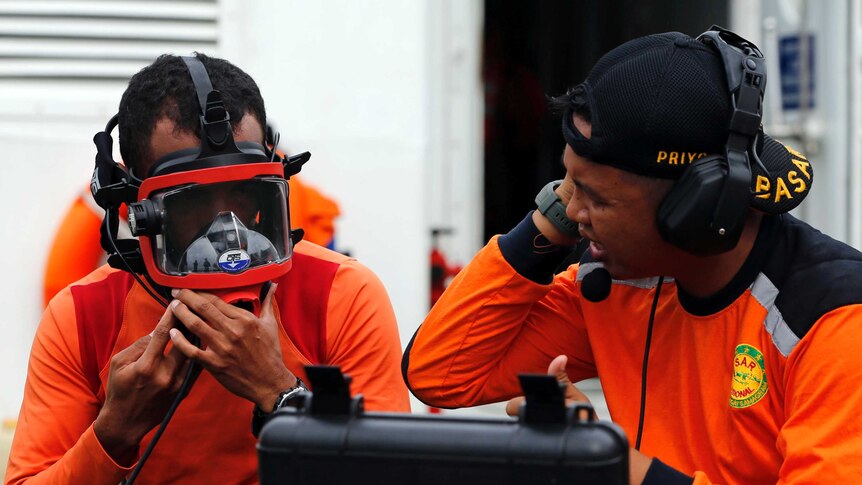 Divers prepare their gear in the search for AirAsia flight QZ8501