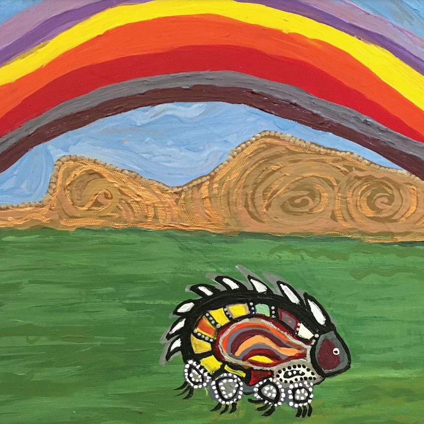 An Aboriginal style painting of a multi-coloured echidna. It is on green grass, and there is a rainbow above it.