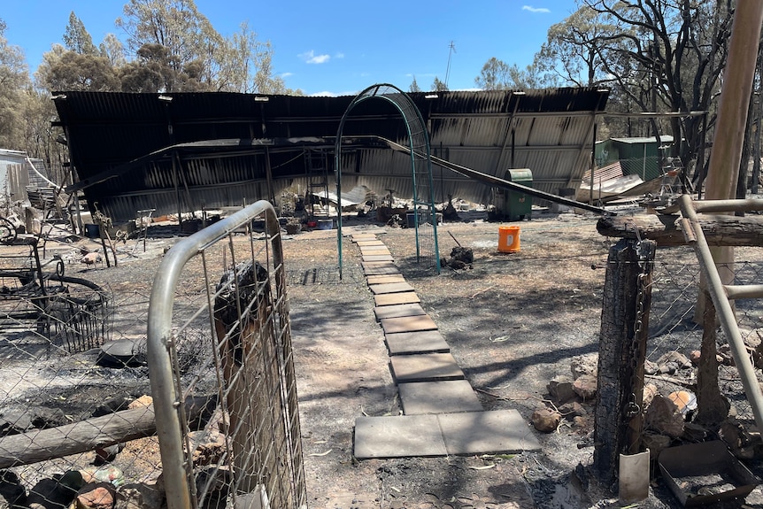 The burnt shell of a tin house.