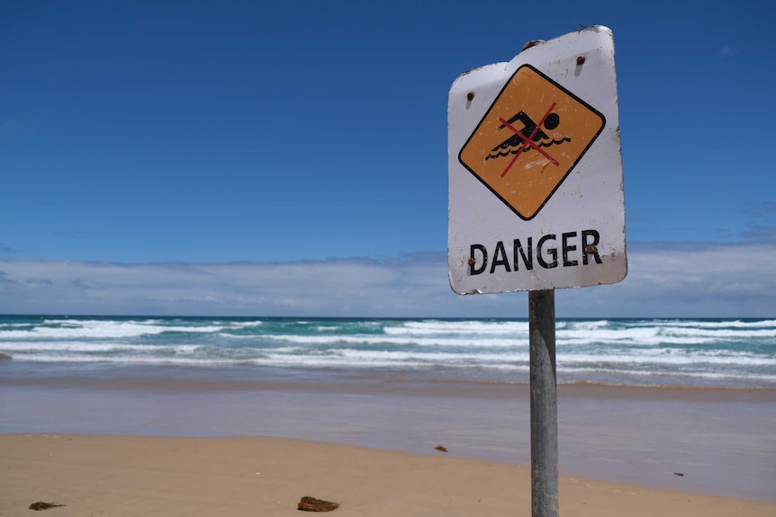 Do not swim warning signs at a beach