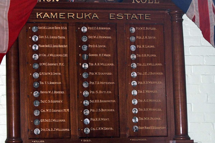 Wooden board with names in gold on it