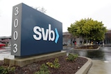 A company sign next to a parking lot displays the numbers 3003 and letters svb