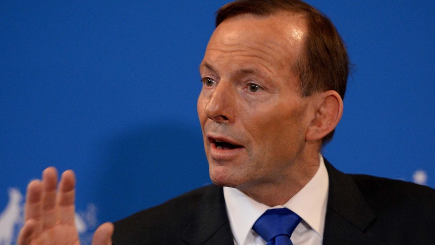 Tony Abbott gestures while addressing media in Sydney