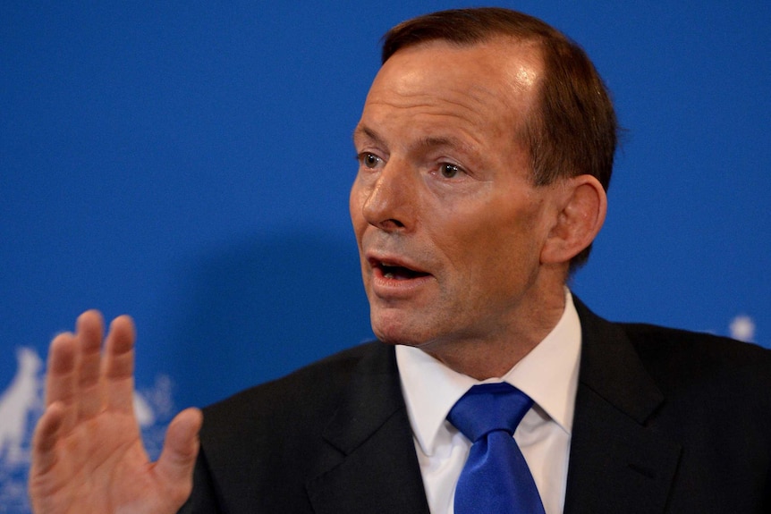 Tony Abbott gestures while addressing media in Sydney