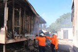 Fire crews put out embers in a building at the Nauru detention centre in late July.