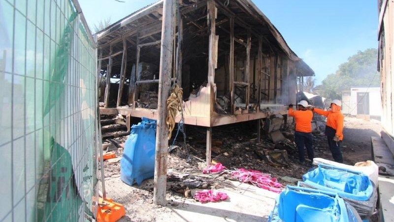 Fire crews put out embers in a building at the Nauru detention centre in late July.