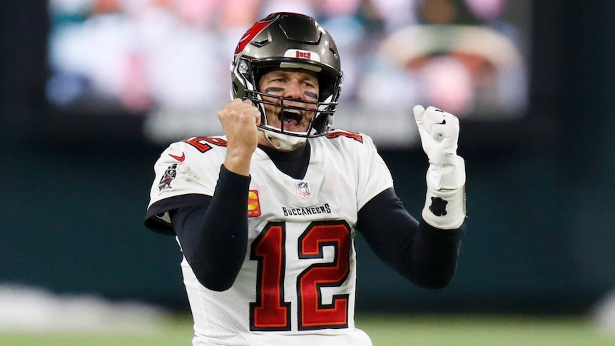 An NFL quarterback pumps his fists and roars in triumph after his team qualifies for the Super Bowl.