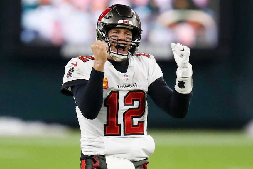 An NFL quarterback pumps his fists and roars in triumph after his team qualifies for the Super Bowl.