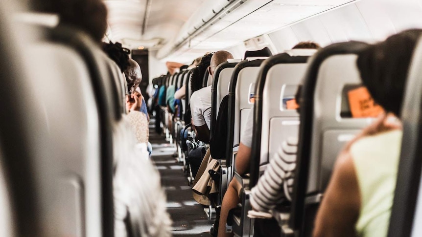 The aisle of a plane's cabin.