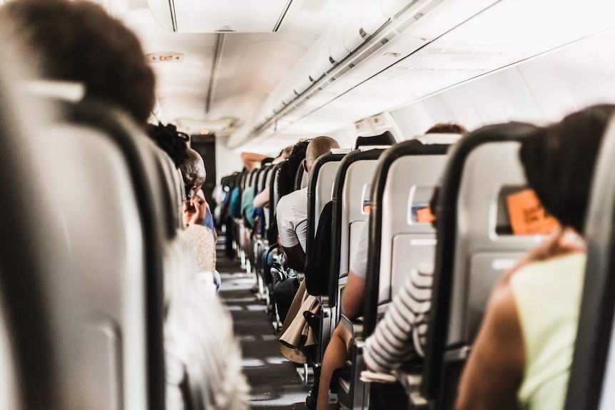 The aisle of a plane's cabin.