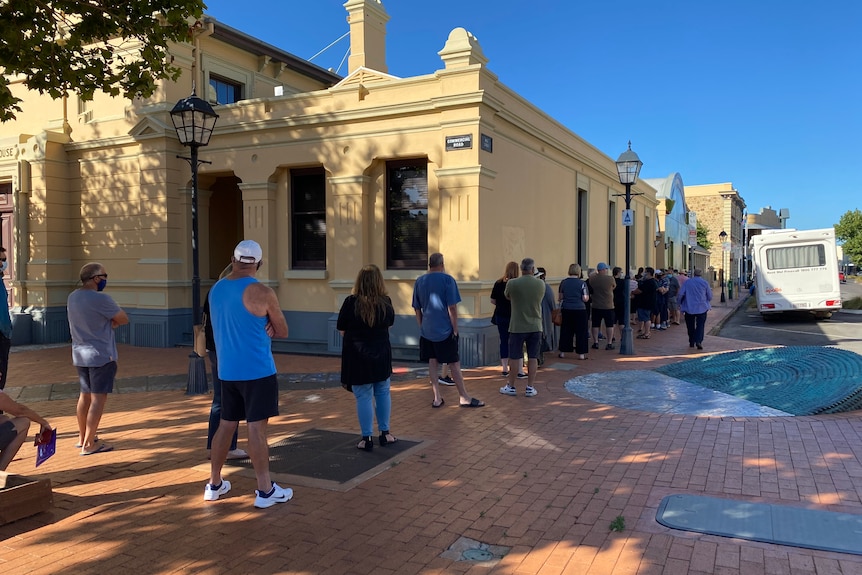 A queue of people awaiting COVID-19 vaccinations at Port Adelaide.