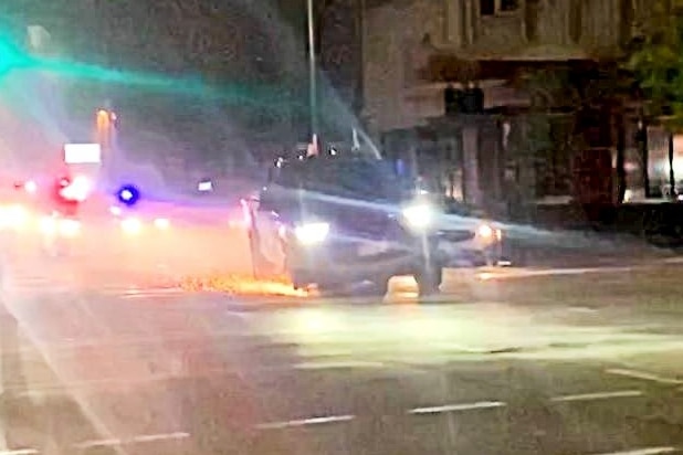 Sparks fly from the punctured wheels of a Ford Ranger as police pursue it through an Adelaide CBD street.