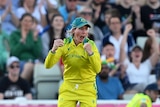 Australia fielder Beth Mooney shouts and pumps her fists after taking a catch in the Commonwealth Games cricket gold medal match
