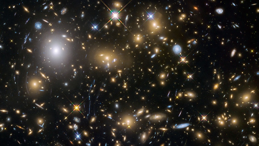 Hubble Space Telescope gravitational lensing image of galaxy cluster MACSJ0717.5+3745