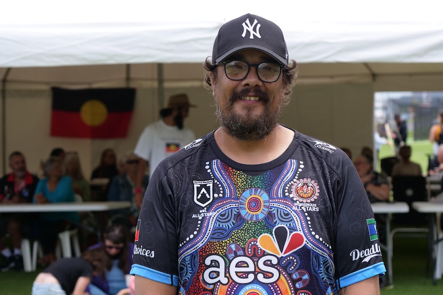 Rodney Kelly wearing a shirt with an indigenous print.  