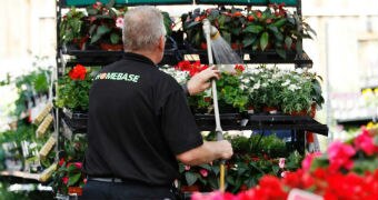 A sales assistant waters plants at a Homebase store in Aylesford.