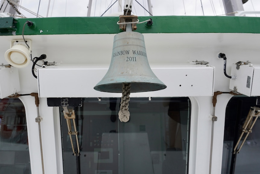 A close-up shot of a bell on board the Rainbow Warrior, with 'Rainbow Warrior 2011' written on it.