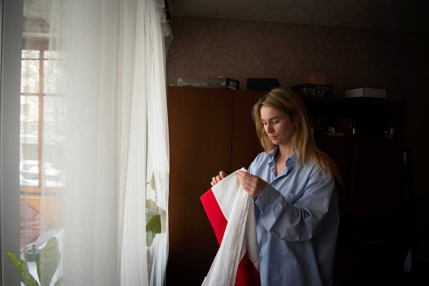 Maria holding a flag.