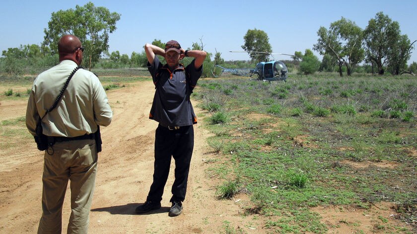 Time for an explanation... Ashley Law talks to a Northern Territory policeman.