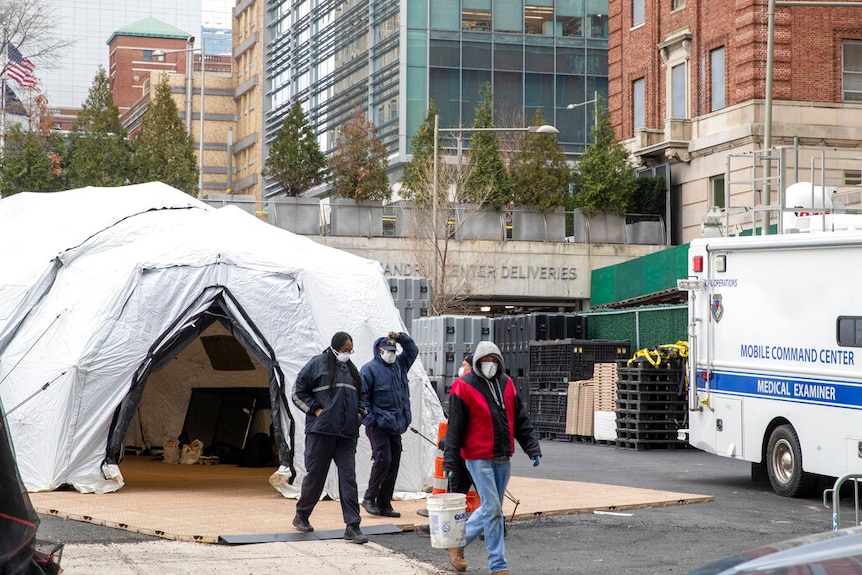 You see an igloo-like structure next to a mobile hospital van.