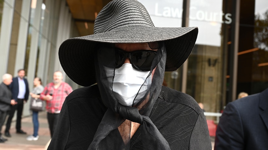 Former teacher Gaye Grant leaves the NSW Court of Criminal Appeal in Sydney with face mask and black hat
