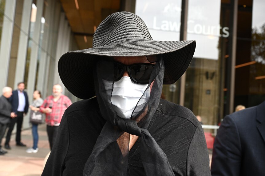 Former teacher Gaye Grant leaves the NSW Court of Criminal Appeal in Sydney with face mask and black hat