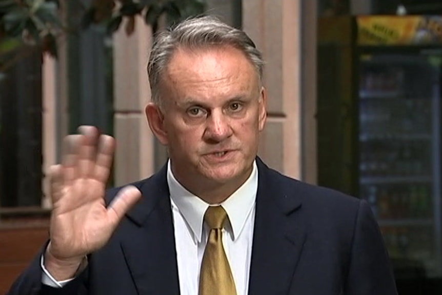 NSW One Nation leader Mark Latham waves his hand at the camera.