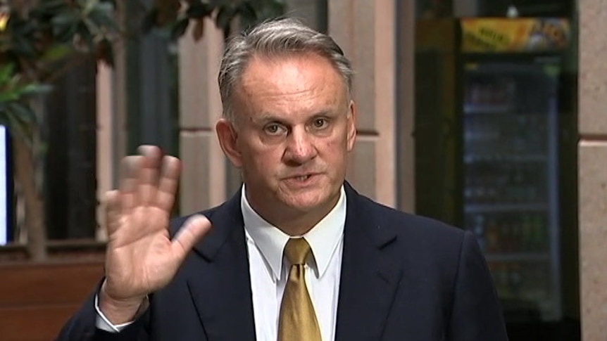 NSW One Nation leader Mark Latham waves his hand at the camera.