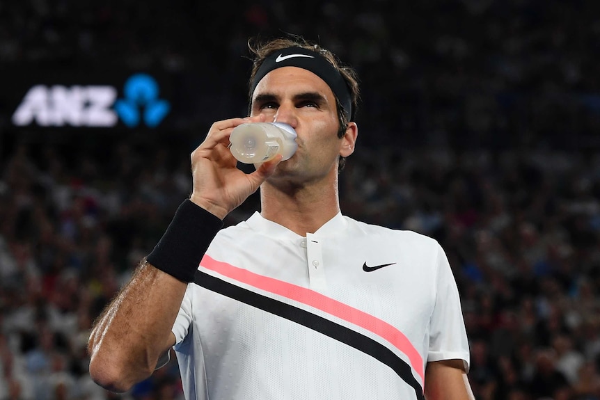 Roger Federer takes a drink from his water bottle during his Australian Open semi-final against Hyeon Chung.