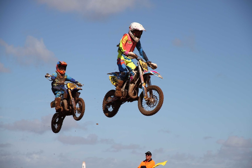 Junior motocross riders jump