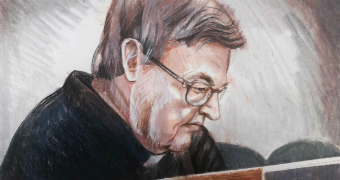 In this court sketch, George Pell sits in court, looking down.