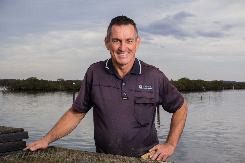 Don Burgoyne stands next to Tilligerry Creek at his oyster farm.