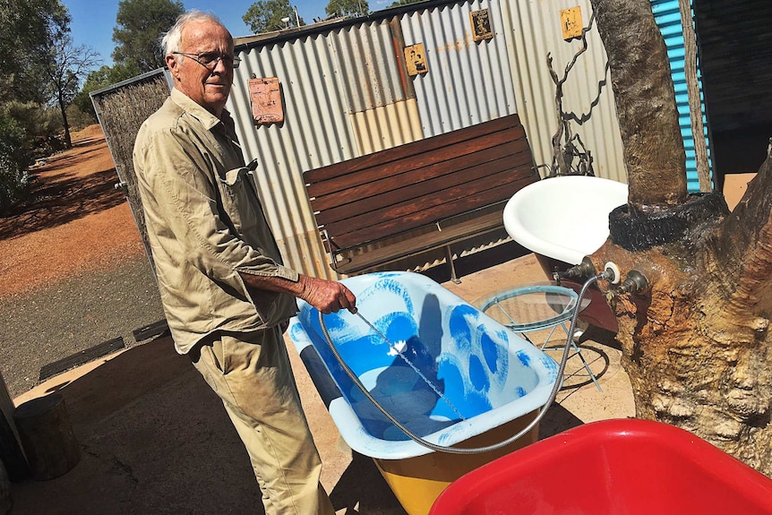 A man fills a bath with water