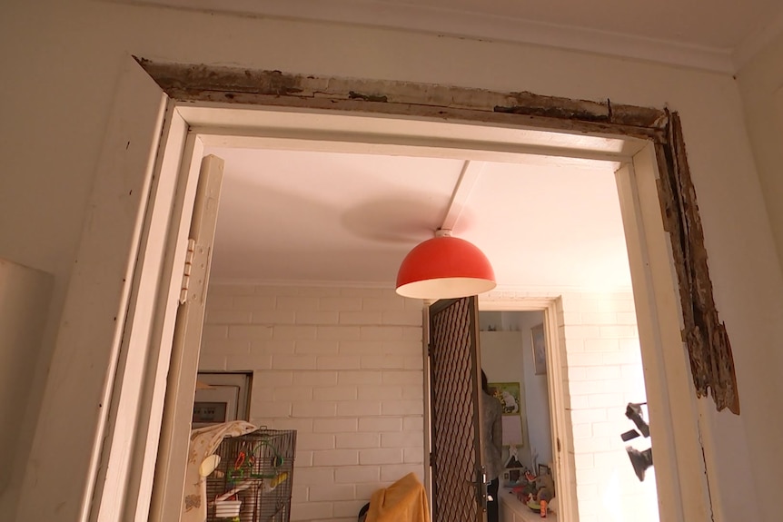 Damage around a door frame in a house