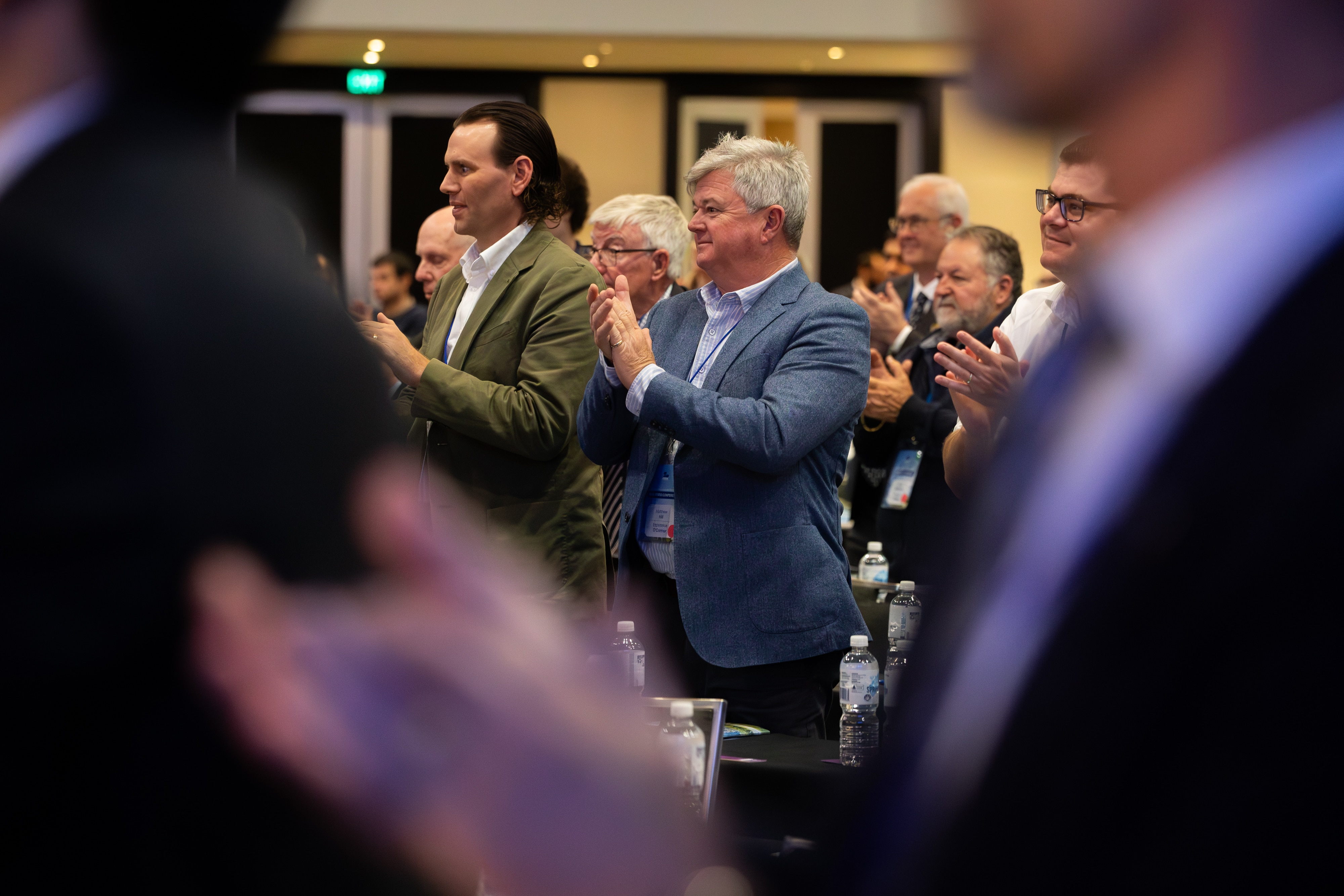 A room of people applauding.