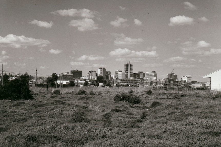 Black and white photograph of empty land with buildings in the distance in Melbourne, 1968.