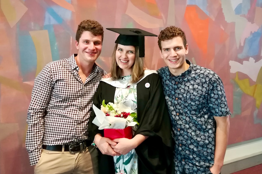 A photo of Kathryn's brothers Jonathan (left), Ryan (right) when she graduated from a Bachelor of Medical Science