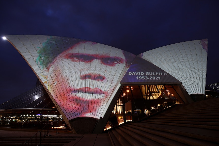 Sydney Opera House Bennelong Sails illuminated to display images of a young David Gulpilil Ridjimiraril Dalaithngu.